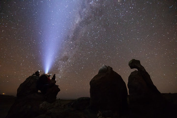 Fototapeta premium The amazing night skies at Atacama Desert, here in the coast area with the Virgin rock formation and its silhouette in front of the sky close to Virgin Beach at Copiapo, an awe and mystic nightscape 