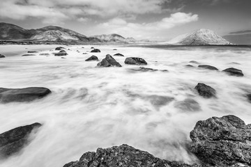 Natural color layers of the blue sky, turquoise waters and brown rocks making a nice pattern at Playa Blanca Beach an awesome and wild beach with  turquoise idyllic waters  inside the Atacama Desert
