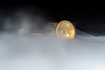 Golden bitcoins with smoke on black background. Business concept. Internet security and protection concept.