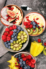 fruit bowl. Bowl of healthy fresh fruit salad on rustic background