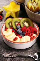 fruit bowl. Bowl of healthy fresh fruit salad on rustic background