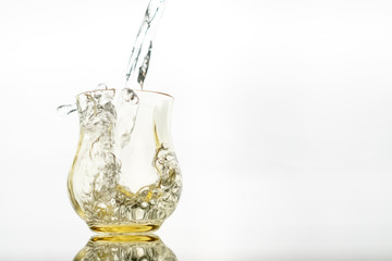 Close up of a fresh drink of water from a bottle in the studio on a white background