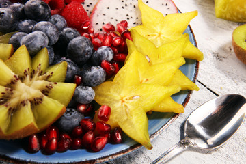 fruit bowl. Bowl of healthy fresh fruit salad on rustic background