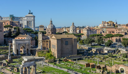Fototapeta na wymiar View of the Roman Forum and the city of Rome from Palatine Hill. The forum with its adjoining buildings is located in the center of ancient Rome. Temples, arches, basilicas and other buildings. 