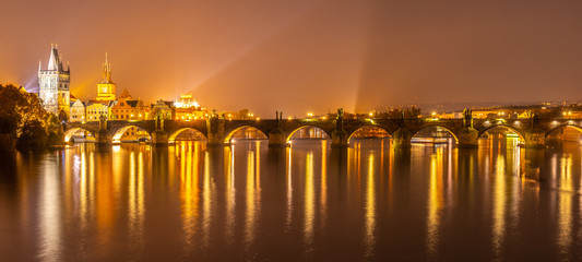 Fototapeta na wymiar Vltava River and Charles Bridge with Old Town Bridge Tower by night, Prague, Czechia. UNESCO World Heritage Site.
