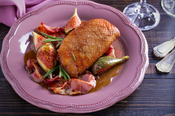 Duck breast with pancetta, rosemary and figs, baked in honey sauce. horizontal