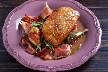 Duck breast with pancetta, rosemary and figs, baked in honey sauce. horizontal