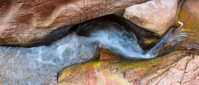 Kanarraville Falls, views from along the hiking trail of falls, stream, river, sandstone cliff formations Waterfall in Kanarra Creek Canyon by Zion National Park, Utah, USA.