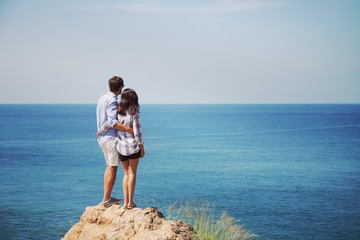 Young couple look at sea