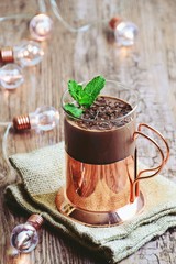 Homemade hot chocolate with mint in a glass cup. Hot chocolate on the wooden background isolated. Hygge style hot 