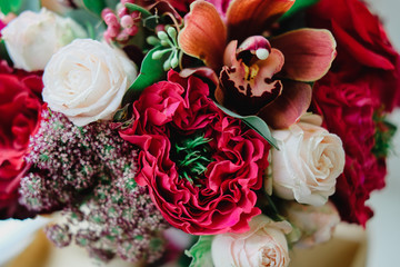 Wedding bouquet with red and white roses of different varieties in autumn colors. Close up flowers.