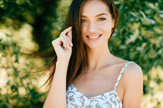 Closeup lifestyle portrait of celebrity female model.  Beautiful girl face on abstract nature background. Cheerful amazing young woman face expression. Sexy blue eyed babe. Glamour youth appearance.