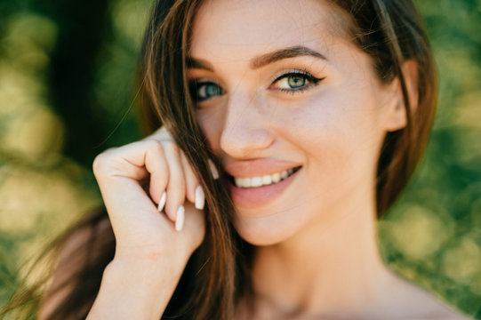 Closeup lifestyle portrait of celebrity female model.  Beautiful girl face on abstract nature background. Cheerful amazing young woman face expression. Sexy blue eyed babe. Glamour youth appearance.