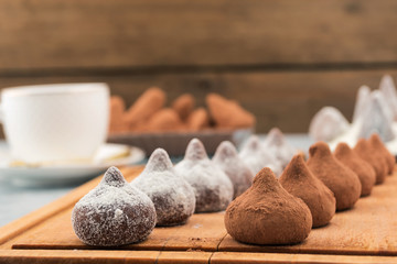 Chocolate candies in white and brown powder.