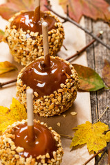 Caramel Apples on Wooden Background. Selective focus.