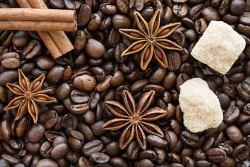 cinnmon sticks, bronw sugar and anise stars on coffee beans background.