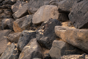 a fragment of a wall assembled from simple gray uneven stones