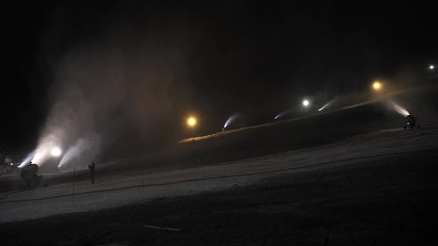 Snow making system in work at night. Snow cannon