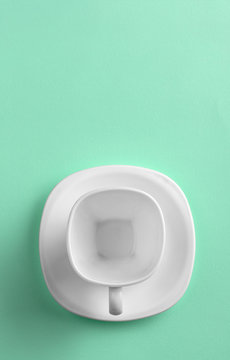 Top view of white cup on green background