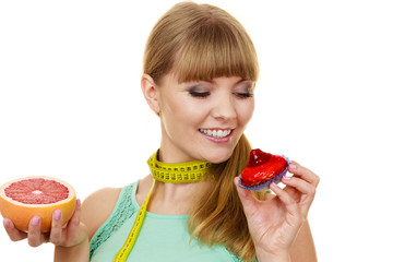Woman choosing fruit or cake make dietary choice