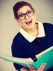 Happy positive business woman holding binder with documents