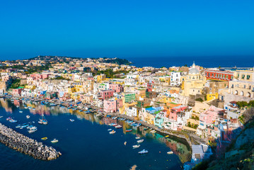 Perfect tiny seaside village with multi colored houses of Marina di Corricella, Procida Island,...