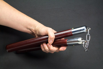 Naklejka premium Nunchaku in black background