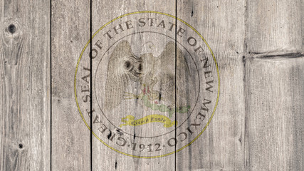 Fototapeta na wymiar USA Politics News Concept: US State New Mexico Seal Wooden Fence Background