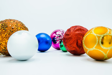 Colorful christmas tree baubles on white background.