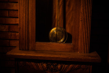 Vintage interior in western style. Big wooden antique clock with pendulum.