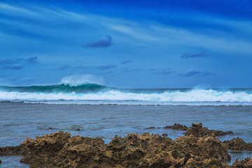 Beautiful sea landscape on the background of dramatic cloudy sky and corals. Siargao island, Philippines