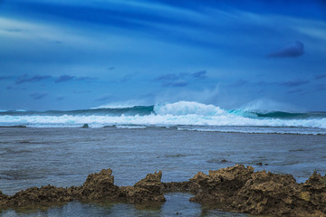 Beautiful sea landscape on the background of dramatic cloudy sky and corals. Siargao island, Philippines