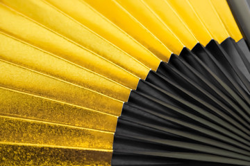 Japanese traditional background material.   新春　お祝い、年賀、正月素材　金色の扇子のクローズアップ　背景素材