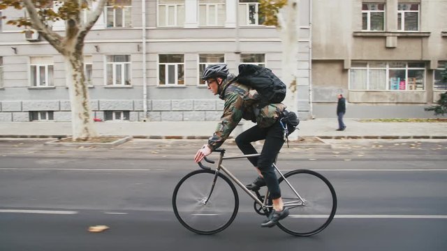 Quick montage cut of young hipster man riding fixed gear bicycle on different loacations, side view. Background is changing