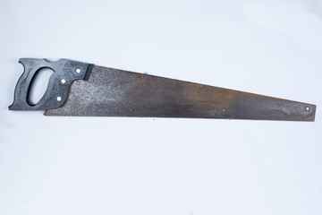 Rusty metal saw against white.