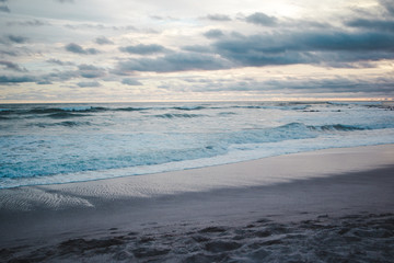 Horizon to shore waves at a cloudy, colourful sunset in Central America