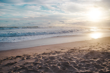 Waves lap at the beach during sunset in Santa Teresa, Costa Rica