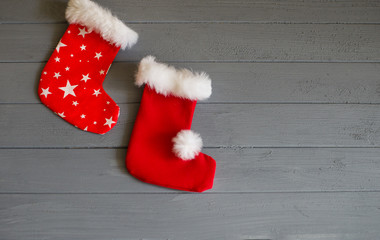 Christmas socks for gifts on a gray background, socks for gifts on the fireplace, socks for gifts for Santa Claus (close up)