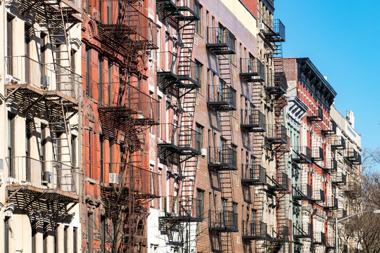 Repeating pattern of fire escapes on colorful old buildings along St. Marks Place in New York City