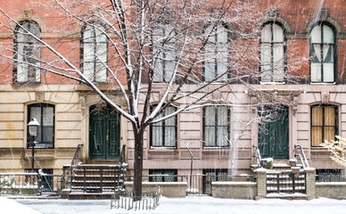Winter scene with snow covered sidewalks along Stuyvesant Street in the East Village neighborhood of New York City