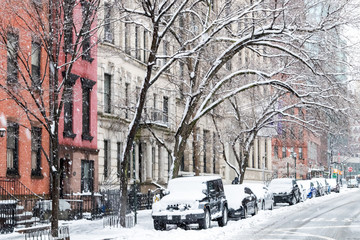 Winter scene with snow covered cars parked along Stuyvesant Street in the East Village New York City