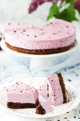 Blueberry cheesecake with chocolate biscuit decorated on a light background