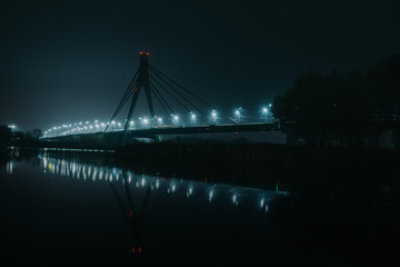 Fototapeta na wymiar Moscow North bridge, night panorama on illuminated construktion with beautiful reflections in Dnipro river