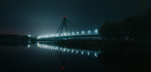 Moscow North bridge, night panorama on illuminated construktion with beautiful reflections in Dnipro river