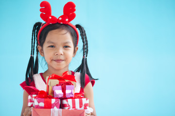 Cute asian child girl holding beautiful gift in hand on Christmas celebration
