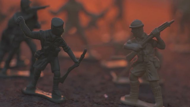 toy model soldier in the fire. The concept of the death of war. slow motion