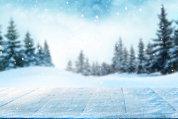 Merry christmas and happy new year greeting background with table .Winter landscape with snow and...