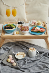 Delicious breakfast in bed served on tray