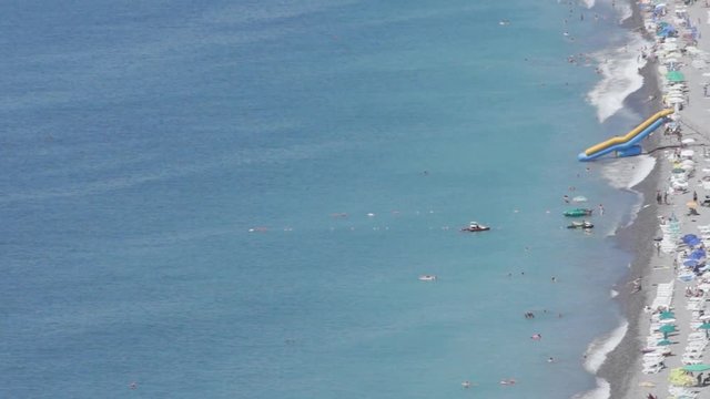 Sea resort coast in the high tourist season. people relax and sunbathing on the beach in Kvariati and Gonio in Adjara. turquoise sea water