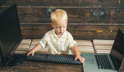 Toddler boy use new technology for online education as part of modern life. Modern life in kindergarten